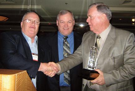 Rod Anderson (right) receiving The William Elton Outstanding Shareholder Award